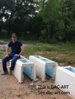 Theodore sitting on one of his DAC-ART stone pieces